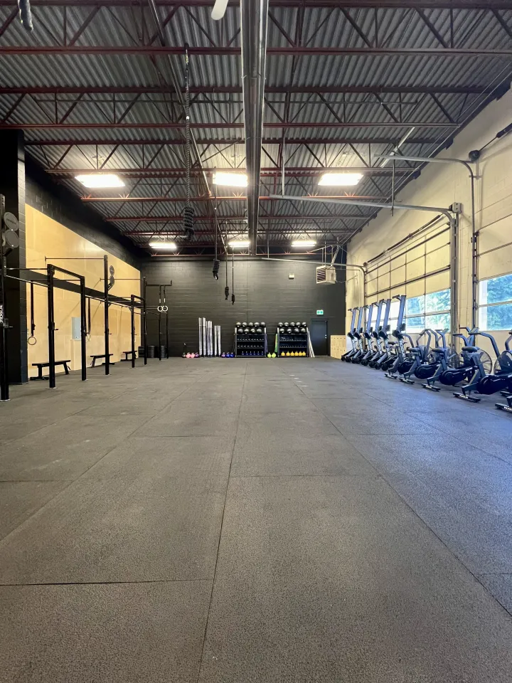The Discovery Strength training floor with rigs and air bikes